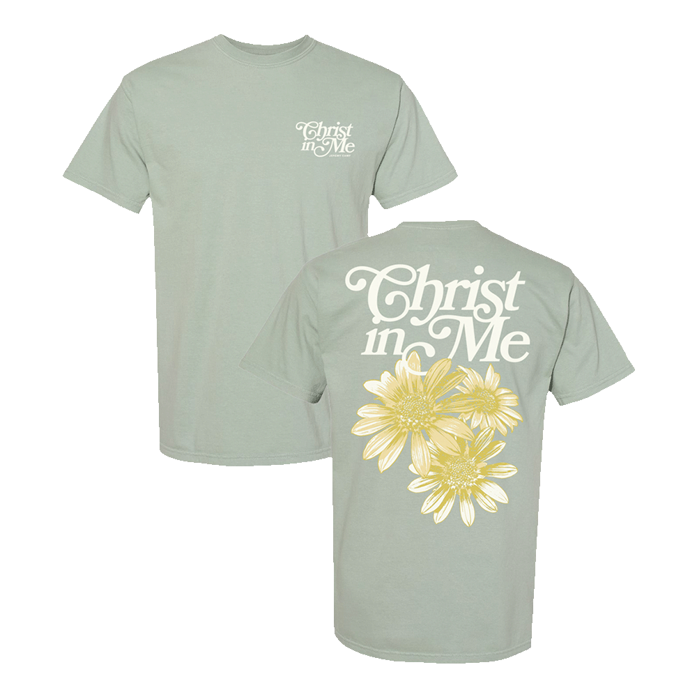 Green t-shirt with 'Christ in Me' text and yellow flowers on the back.